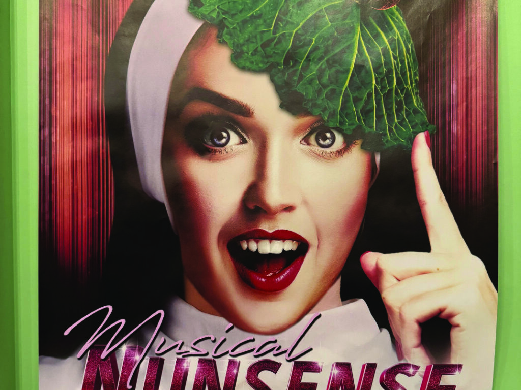 Ein Plakat des Musicals „Nunsense“: eine als Nonne verkleidete Person mit einem Kohlblatt als Haube hält lächelnd den Zeigefinger hoch.